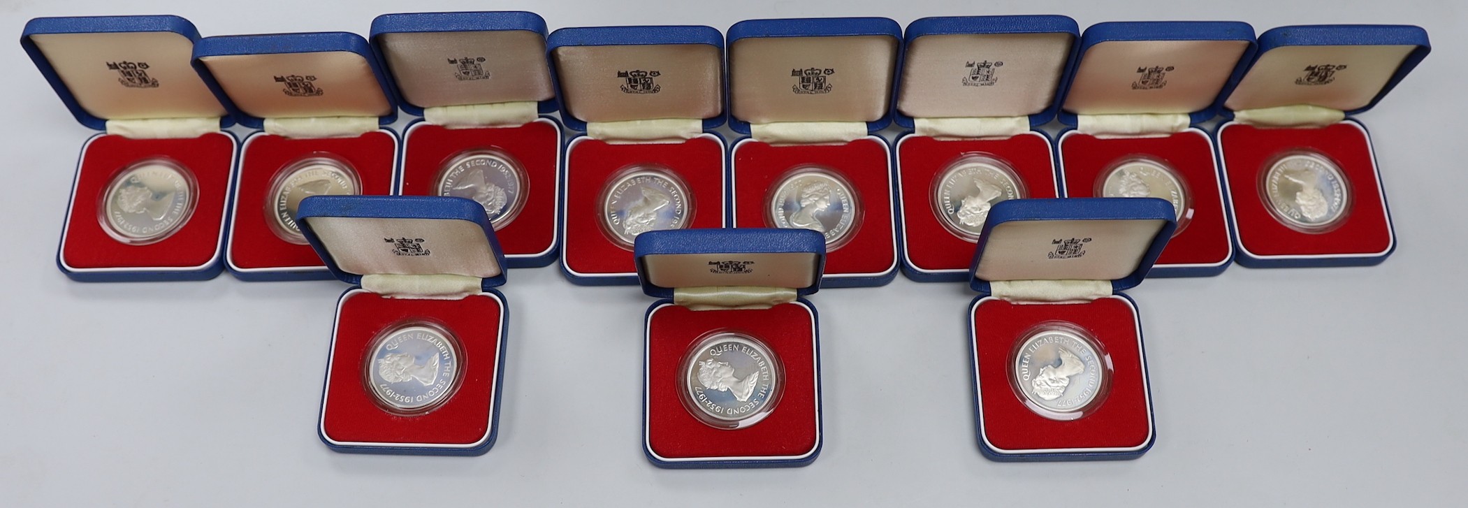 Eleven Royal Mint Commonwealth commemorative proof silver crowns